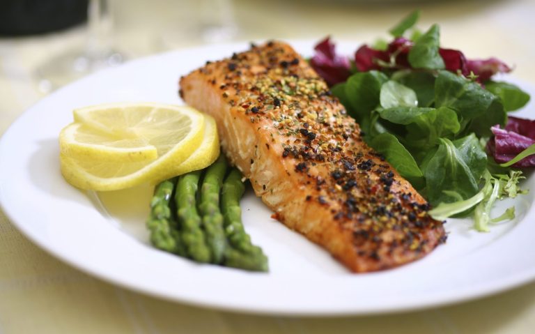 Vegetarisches Catering Berlin mit gegrilltem Lachs mit Zitronenscheiben, Spargel und gemischtem Salat.